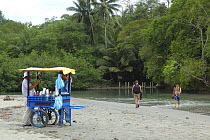 Tourists and trader on the beach, Manuel Antonio National Park, pacific coast of Costa Rica