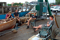 Shipwrights taking a tea break at the Underfall Boatyard. Bristol Floating Harbour, England. July 2008