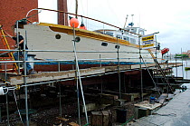 Motor yacht pulled up out of the water at the historic slipway of Underfall Boatyard, Bristol Floating Harbour, UK. July 2008, Model Released