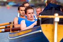 Strained faces on stroke side as Bristol Pilot Gig Club's Men's crew practice in their gig "Isambard" on Bristol's Floating Harbour, UK. July 2008, Model Released