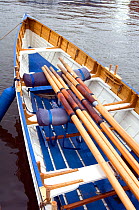 Oars on seats in bow of Bristol Pilot Gig Club's "Isambard" on Bristol's Floating Harbour, England, UK    , July 2008