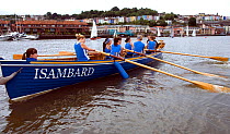 Bristol Pilot Gig Club's Ladies crew practicing in their gig "Isambard" on Bristol Floating Harbour, with the city skyline of Clifton Wood and Hotwells in the background. England, UK. July 2008, Model...