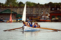 Bristol Pilot Gig Club's Ladies crew practicing in their gig "Isambard" on Bristol Floating Harbour, with historic Underfall Yard in the background. England, UK. July 2008, Model Released