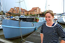 Woman outside her Dutch barge moored in Marina, Bristol Floating Harbour, UK. July 2008, Model Released