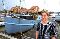Woman outside her Dutch barge moored in Marina, Bristol Floating Harbour, UK. July 2008, Model Released