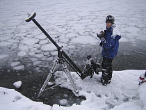 Photographer with camera on boom in Antarctica 2005