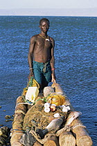 Fisherman with catch on his raft boat, Lake Turkana, Kenya, 2006