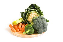 Fresh mixed vegetables: Broccoli, Celery, Carrots, Cauliflower and Green Pepper on kitchen chopping board