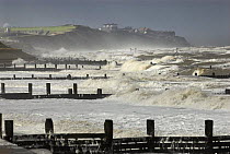 Waves breaking on groynes, looking towards Mundesley, North Norfolk, Uk