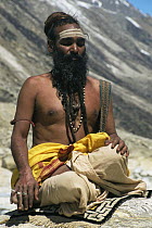 A Hindu Saddhu sitting and praying at the source of the Ganges, Himalayas, India
