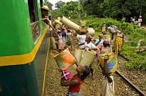 Traders selling goods to people on a train, Manakara, Madagascar