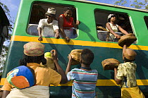 Traders selling goods to people on train, Manakara, Madagascar