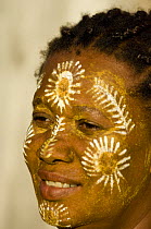 Malagassy woman with painted face from the tribe Antakarana, Nosy Be, Madagascar.