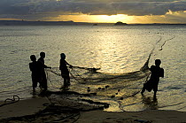 Fishermen pulling in the nets at dawn, Ramena beach, Diego Suarez (Antsiranana), North Madagascar.