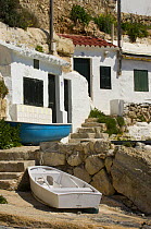 Village houses cut into the cliffs, Cala d'Alcaufar, Menorca Island, Balearic Islands, Spain