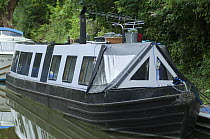 A modernised narrowboat moored in Brassknocker Basin near the junction with the Kennet and Avon Canal at Dundas Aqueduct, Wilshire, England