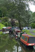 Boats moored in Brassknocker Basin near the junction with the Kennet and Avon Canal at Dundas Aqueduct, Wilshire, England
