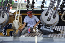 Crew member of "Kaskelot" tall ship polishing the ship's bell, Bristol Harbour Festival, August 2008