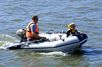 Man and boy in dinghy with outboard motor at the Bristol Harbour Festival, August 2008