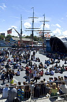 Crowds in the amphitheatre at the Bristol Harbour Festival with sailing ship Kaskelot in the background. August 2008