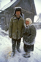 Vasily and Maria Balakhonovy outside their home in a remote village with no stores or means of transport, Chukhrai, Bryansk Province