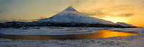 DUPLICATE IMAGE  Kronotsky Volcano in March Kronotsky Zapovednik The Kronotsky River winds before the volcano of the same name in a snowy winterscape in March on Russia's Kamchatka Peninsula.