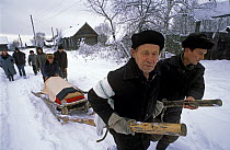 Village burial, Chukhrai, Bryansk Province, Russia. Villagers pull the coffin of the late Evdokiya Balakhonva to the graveyard for burial.