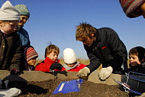 Children being taught about the importance of composting organic matter, France