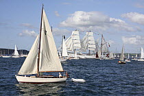 Bermudan Sloop at the Funchal 500 Tall Ships Regatta race day, with tall ship "Cuauhtemoc" in the background. Saturday 13th September 2008. Falmouth, Cornwall, UK