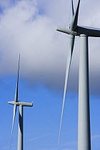 Two wind turbines against a blue sky with clouds, Cumbria, UK