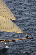 Man on bowsprit of cutter "Moonbeam" at Douarnenez Maritime Festival, France, July 2008