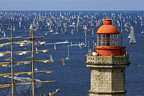 Tall ship passes lighthouse at The Grand Parade at Douarnenez Maritime Festival, France, July 2008
