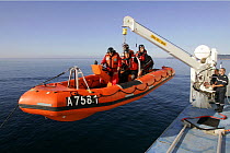 Starboard inflatable lifeboat launching into the Mer d'Iroise sea during an exercise, France, August 2005
