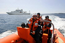 Crew of inflatable lifeboat on exercise, Mer d'Iroise sea, France, August 2005