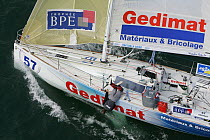 Skipper leaning over the side of his yacht "Gedimat" (Number 57) as it departs Saint Nazaire for the Figaro solo Transatlantic Race BPE Trophy, April 2005