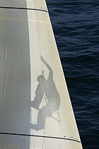 Gildas Morvan climbing rigging on yacht "Cercle Vert" during Figaro solo Transatlantic race, March 2005