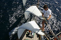 Man clipping rigging on schooner "Goelette", Douarnenez International Maritime Festival, July 2006