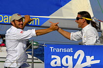 Skipper Eric Peron and co-skipper Miguel Danet celebrating with champagne after Transatlantic AG2R race, 2008. St Barths, 2008