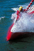 Jean Luc van den Heede on bow of monohull "Algimouss" attempting world record circumnavigation, 1999