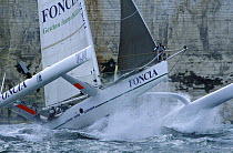 Alain Gautier 60ft trimaran "Foncia" under sail beside high cliffs, Grand Prix de Fecamp, 2001