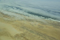 Coast of Namibia from the air with cloud and sea-mist, between Swakopmund and the Skeleton Coast. Namibia. July 2008.