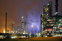 Lightning during thunderstorm above petrochemical industry, Antwerp harbour, Belgium. July 2008.