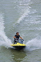 Man riding jet ski on the North Sea, Belgium, 2008.
