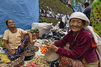 Women selling vegetables at street market stall,  Sombare, West Sikkim, India October 2007