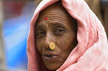 Woman (of Nepali origin) with nose jewellery at the market of Sombare, West Sikkim, India October 2007