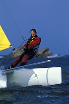 Young woman learning to sail a New Cat 16 catamaran at sailing school "Club Newmarine", France 2002