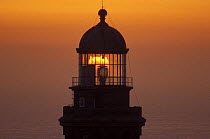 Sun setting behind the Lantern of L'ile Vierge lighthouse, Finistere, Brittany, France