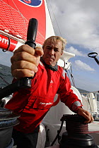 Skipper Roland Jourdain winching aboard Monohull Open 60ft "Veolia Environment" during Vendee Globe 2008-2009, October 2008.
