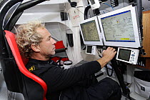 Skipper Roland Jourdain consulting maps aboard Monohull Open 60ft "Veolia Environment" during Vendee Globe 2008-2009, October 2008.