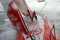 Skipper Roland Jourdain pulling in sheets on Monohull Open 60ft "Veolia Environment" during Vendee Globe 2008-2009, October 2008.